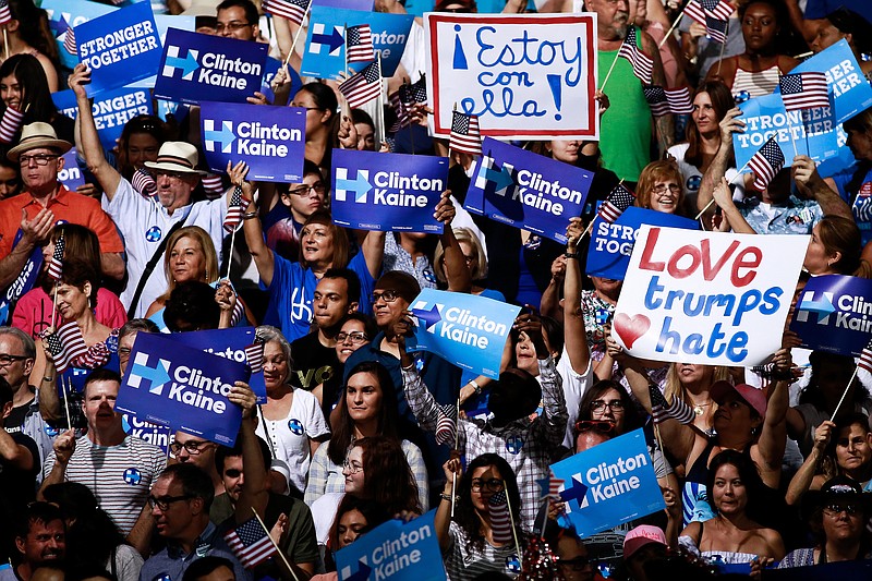 Signs in the crowd as supporters cheer for Hillary Clinton and Sen. Tim Kaine. (Scott McIntyre/The New York Times)