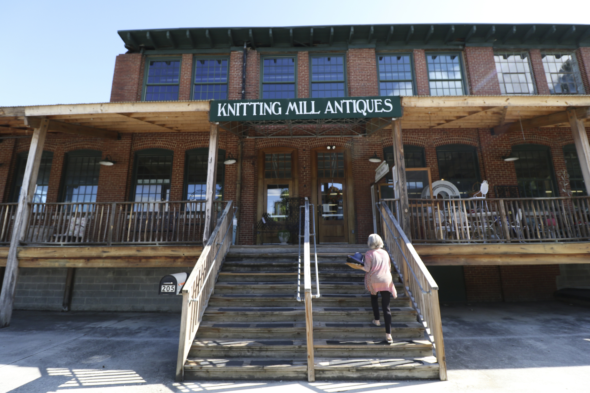 Staff Photo by Dan Henry / The Chattanooga Times Free Press- 7/27/16. A vendor enters Knitting Mill Antiques which was recently purchased and will become the Signal Mill office and retail development complex.