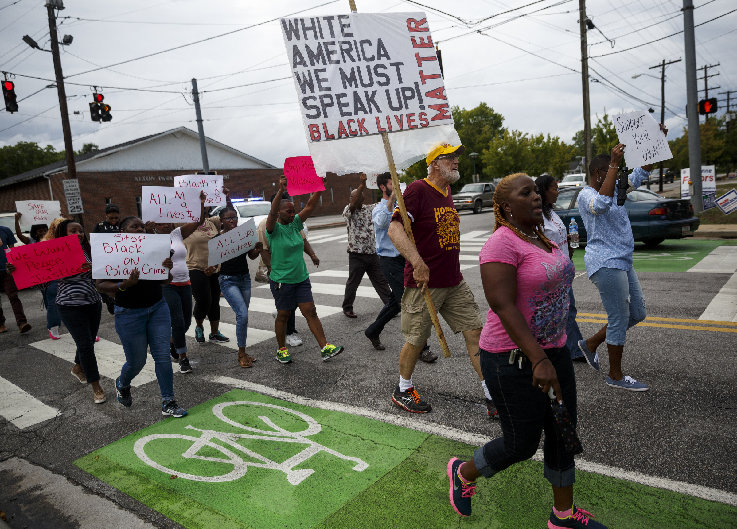 Demonstrators march along East 38th Street from South Chattanooga Recreation Center to Westside Baptist Church before a town hall meeting at the church to discuss race relations and poverty Thursday, July 28, 2016, in Chattanooga, Tenn. A panel of speakers took part in a discussion about race, poverty, and policing.