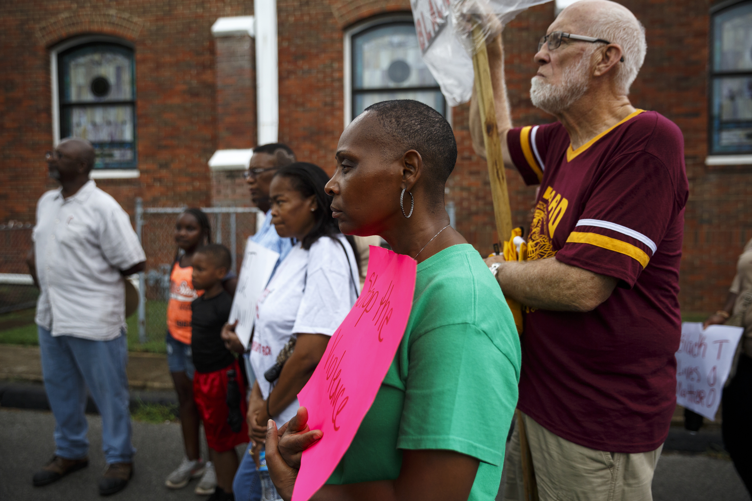 Linda Tooks, center, and Franklin McCallie, right, listen with other demonstrators to a speaker before a town hall meeting to discuss race relations and poverty at Westside Baptist Church on Thursday, July 28, 2016, in Chattanooga, Tenn. A panel of speakers took part in a discussion about race, poverty, and policing.