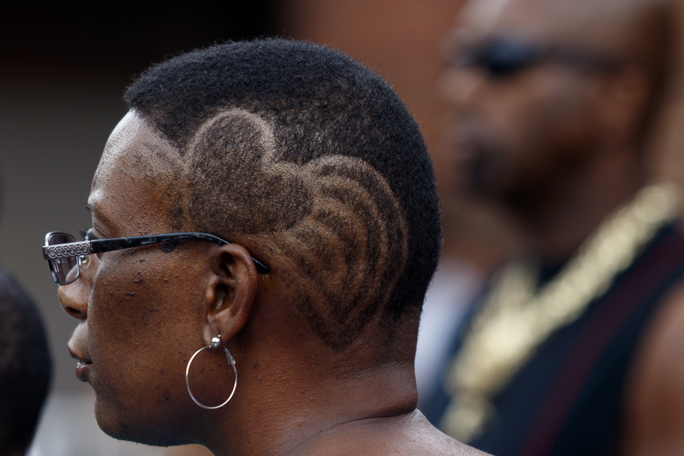 Yolanda Jones has a heart shaved into her hair as she listens to a speaker before a town hall meeting to discuss race relations and poverty at Westside Baptist Church on Thursday, July 28, 2016, in Chattanooga, Tenn. A panel of speakers took part in a discussion about race, poverty, and policing.