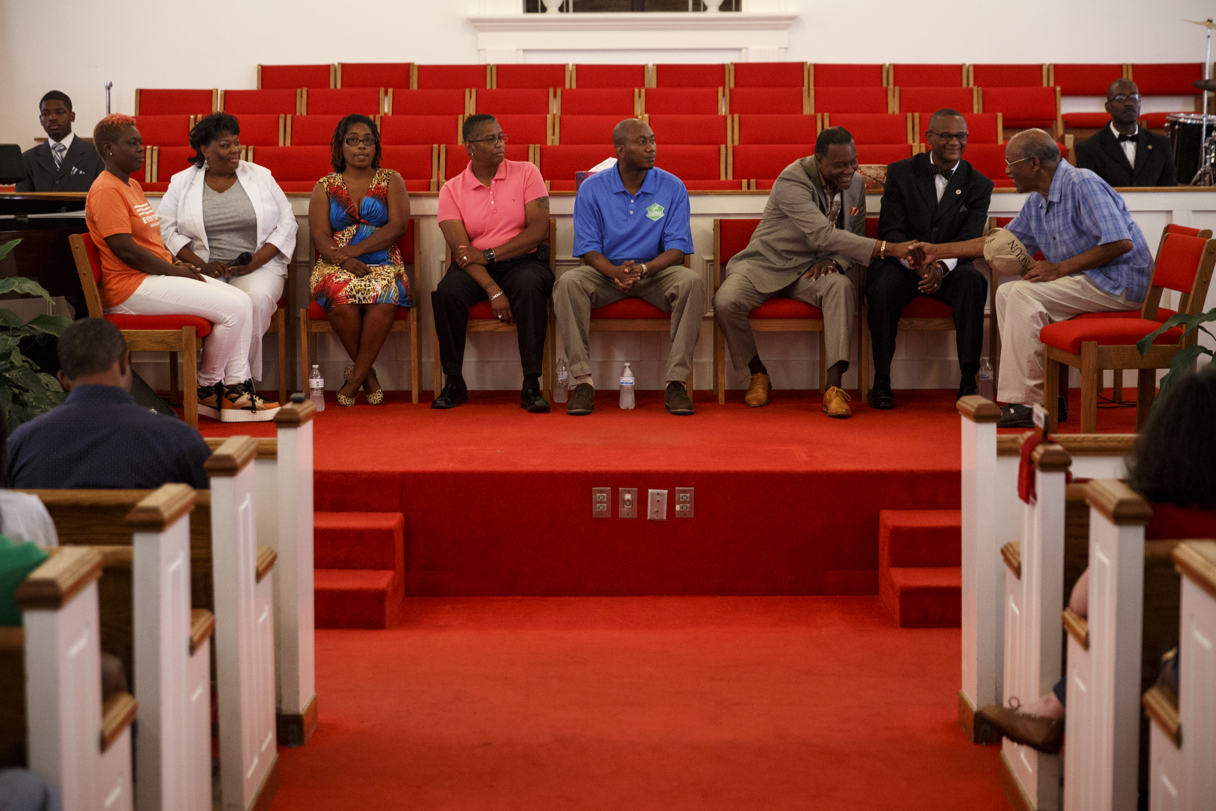 Panelists greet one another before a town hall meeting to discuss race relations and poverty at Westside Baptist Church on Thursday, July 28, 2016, in Chattanooga, Tenn. A panel of speakers took part in a discussion about race, poverty, and policing.