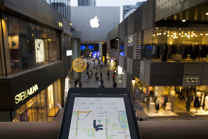 
              FILE - In this Friday, May 13, 2016 file photo, a mobile device shows the Didi Chuxing ride-hailing app at a shopping mall in Beijing, China. China's Cabinet issued a document Thursday, July 28, 2016, outlining guidelines for ride-hailing services and has told local governments to promote its booming ride-hailing industry, helping to confirm the legal status of Uber Technologies Ltd. and local competitors following run-ins with regulators. (AP Photo/Ng Han Guan, File)
            