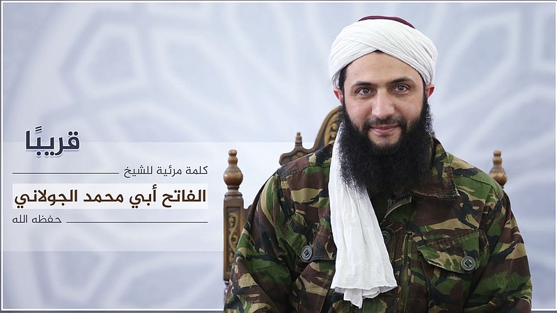 Nusra Front leader Mohammed al-Golani undated photo released online on Thursday, July 28, 2016, to announce a video message that the militant group is changing name, and claims it will have no more ties with al-Qaida. In a video aired on the Syrian opposition station Orient TV and Al-Jazeera al-Golani said the delinking from the terror network aimed to remove "pretexts" by the U.S. and Russia to strike other rebel groups while claiming they are targeting Nusra. Arabic reads, "coming soon, a video by the conqueror, Mohammed al-Golani."