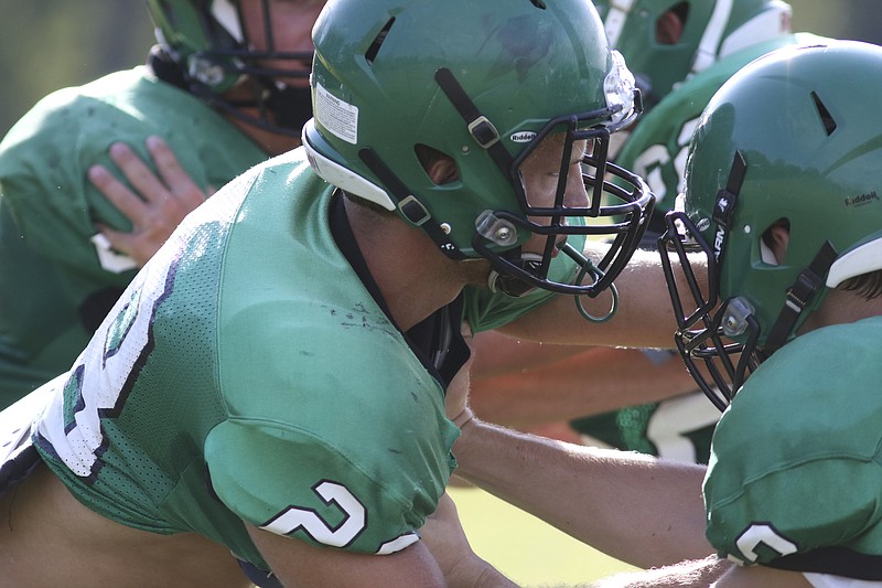 East Hamilton's Ian Ammerall (28) runs drills with his team during football practice Wednesday. Ammerall is the Hurricanes' most experienced defensive player, and he has moved to safety.