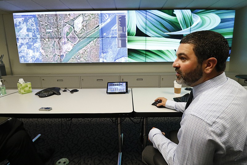 Nick McClung, TVA's manager for risk and quality assurance, answers questions during an interview in the ATIM Center where numerous sensors can be monitored to determine the stability of earthen dams that contain coal ash. 