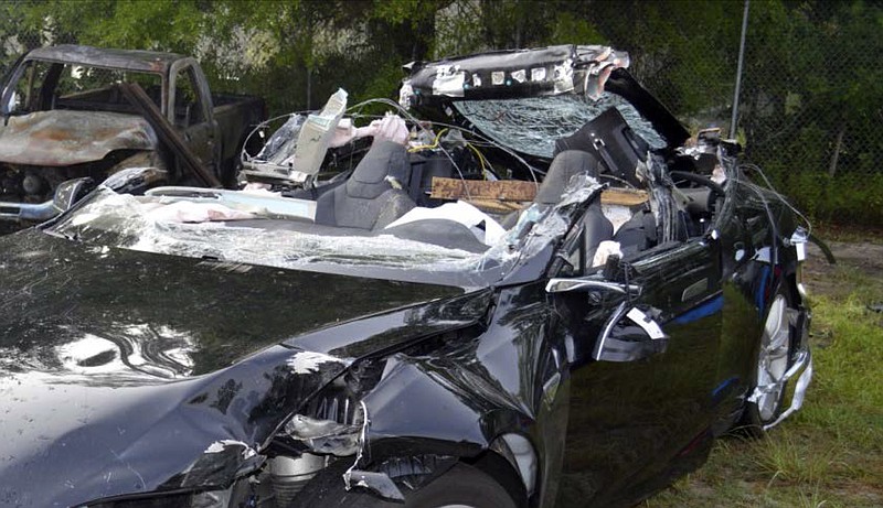 
              FILE - This file photo provided by the National Transportation Safety Board via the Florida Highway Patrol shows the Tesla Model S that was being driven by Joshua Brown, who was killed when the Tesla sedan crashed while in self-driving mode on May 7, 2016. A person familiar with the discussions says Tesla has told Senate committee staffers that its engineers have two main theories about what caused the fatal crash. Both involve the car's cameras and radar. Tesla officials disclosed the theories a briefing with U.S. Senate Commerce Committee staff members Thursday, July 28, 2016, said the person, who didn't want to be identified because the meeting was private. (NTSB via Florida Highway Patrol via AP, File)
            