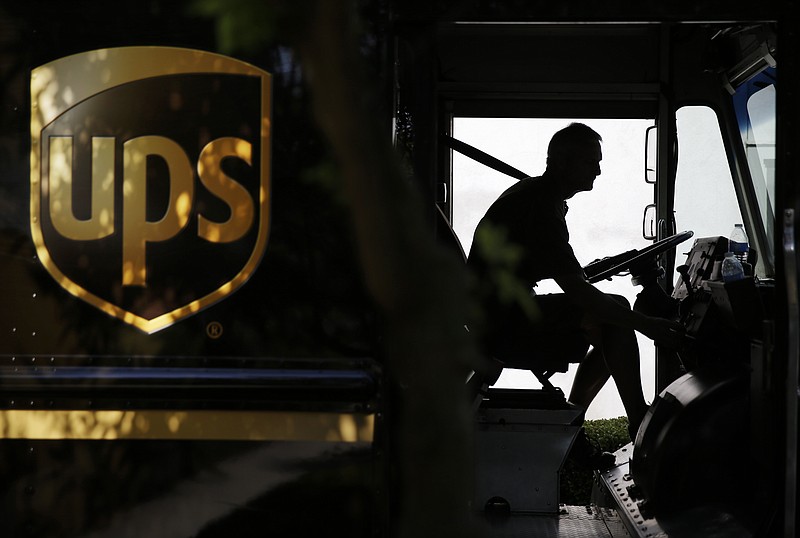 
              FILE - In this June 20, 2014, file photo, a United Parcel Service driver starts his truck after making a delivery in Cumming, Ga. UPS reports financial results on Friday, July 29, 2016. (AP Photo/David Goldman, File)
            