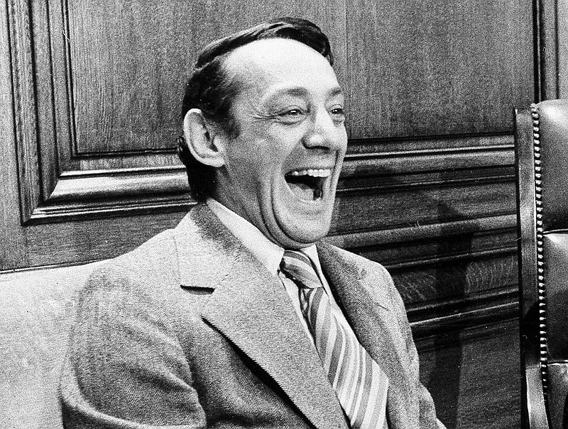 
              FILE - In this April 1977 file photo, San Francisco supervisor Harvey Milk sits in the mayor's office during the signing of the city's gay rights bill in San Francisco. The late gay rights leader Milk already has schools, streets and parks named in his honor. Soon, a U.S. Navy ship will join the list. A Navy official said Friday, July 29, 2016, that Navy Secretary Ray Mabus notified Congress earlier this month that a new fleet of replenishment oilers being built in San Diego will be named for Milk and five other civil and human rights icons. (AP Photo/File)
            
