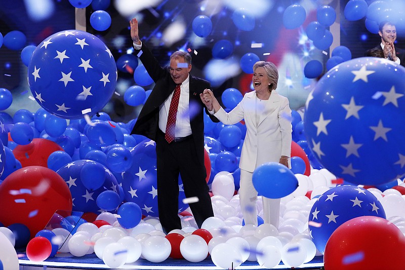 Democratic vice presidential nominee Sen. Tim Kaine, D-Va., and Democratic presidential nominee Hillary Clinton walk through the falling balloons during the final day of the Democratic National Convention in Philadelphia , Thursday, July 28, 2016. (AP Photo/J. Scott Applewhite)