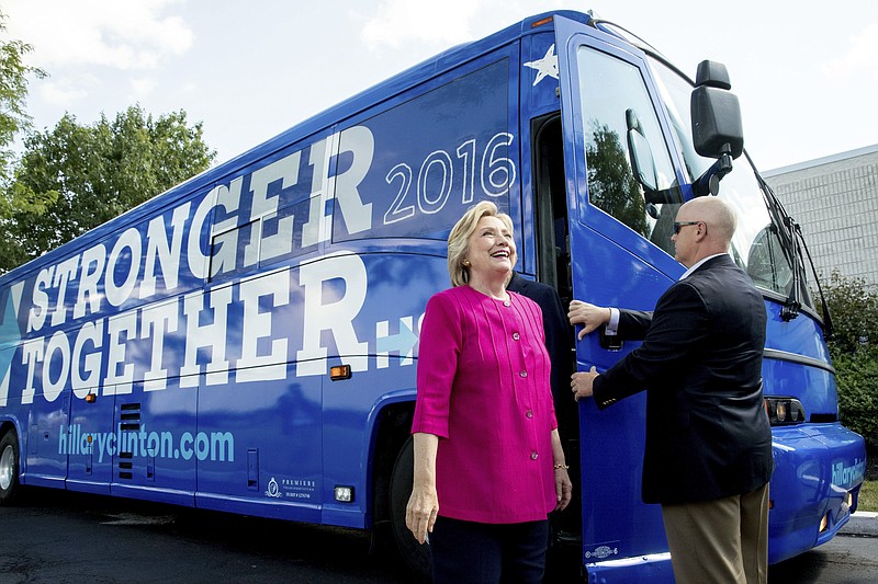 Democratic presidential candidate Hillary Clinton gets off her campaign bus as she arrives for a rally at K'NEX, a toy company in Hatfield, Pa., Friday, July 29, 2016. Clinton and Kaine begin a three day bus tour through the rust belt. (AP Photo/Andrew Harnik)