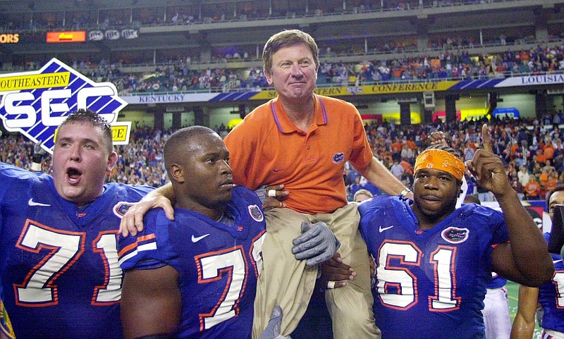 
              FILE - In this Dec. 2, 2000, file photo, Florida head coach Steve Spurrier is carried off the field after the Gators downed Auburn 28-6 in the SEC Championship at the Georgia Done in Atlanta. Players from left are  by Mike Pearson (71), Kenyatta Walker (78) and Gerard Warren (61).  Spurrier already has a statue outside of the football stadium and the field named after him. Next he'll serve as ambassador and consultant for the school's entire athletic department.
Gators athletic director Jeremy Foley made the announcement on Friday, July 29, 2016.
(AP Photo/John Bazemore, File)
            