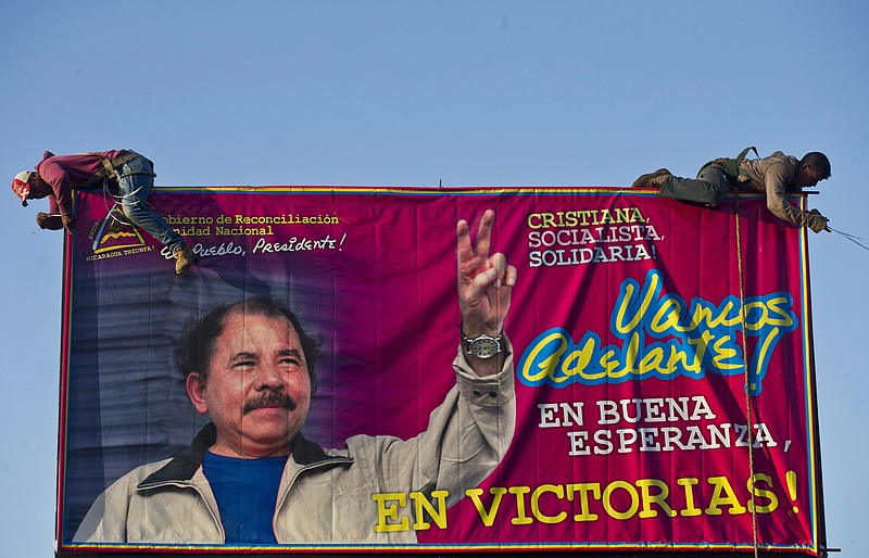 
              FILE - In this Dec. 21, 2015 file photo, workers install a billboard supporting Nicaragua's President Daniel Ortega along a street Managua, Nicaragua. The banner's message reads in Spanish: "Let's move ahead! In good hope, in victories!"  The Supreme Electoral Council unseated 16 opposition legislators from the Liberal Independent Party and its ally the Sandinista Renovation Movement Friday, July 29, 2016, for not recognizing their leader. That leader, Pedro Reyes, had recently been given that authority by the Supreme Court, which removed the party’s previous leader following a long-running political dispute. Reyes is seen by some within his own party as a tool of Ortega. (AP Photo/Esteban Felix, File)
            