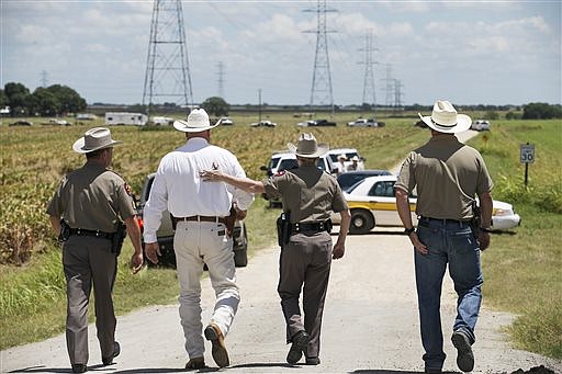 Officers walk toward the scene of the balloon crash.