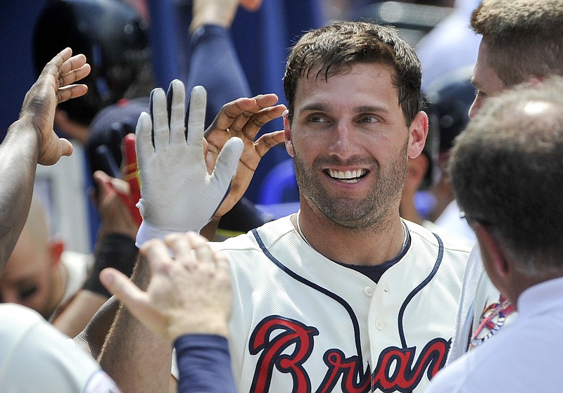 Atlanta Braves' Jeff Francoeur is congratulated in the dugout after his two-run home run during the seventh inning of a baseball game against the Philadelphia Phillies, Sunday, July 31, 2016, in Atlanta. (AP Photo/John Amis)