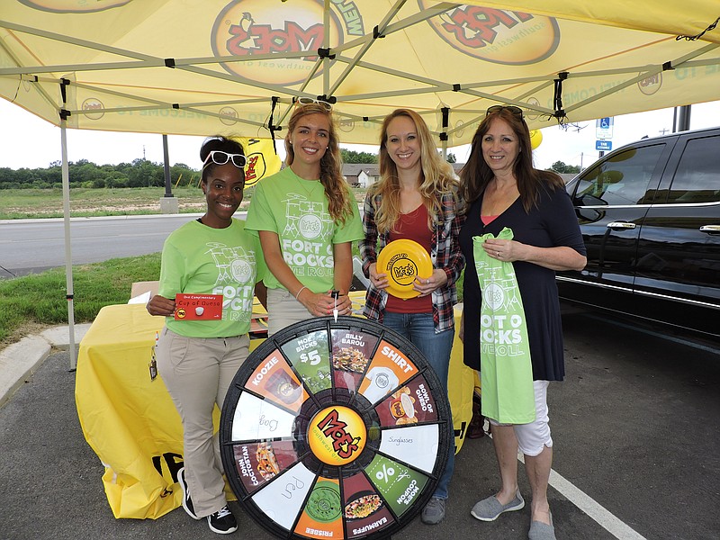 Moe's Southwest Grill brand ambassadors give customers a chance to spin a wheel for prizes at the restaurant's grand opening in Fort Oglethorpe. From left are brand ambassadors Meredith Seay and Samantha Crawford, and customers Alyssa Newman and her mother Karen, both of Ringgold.