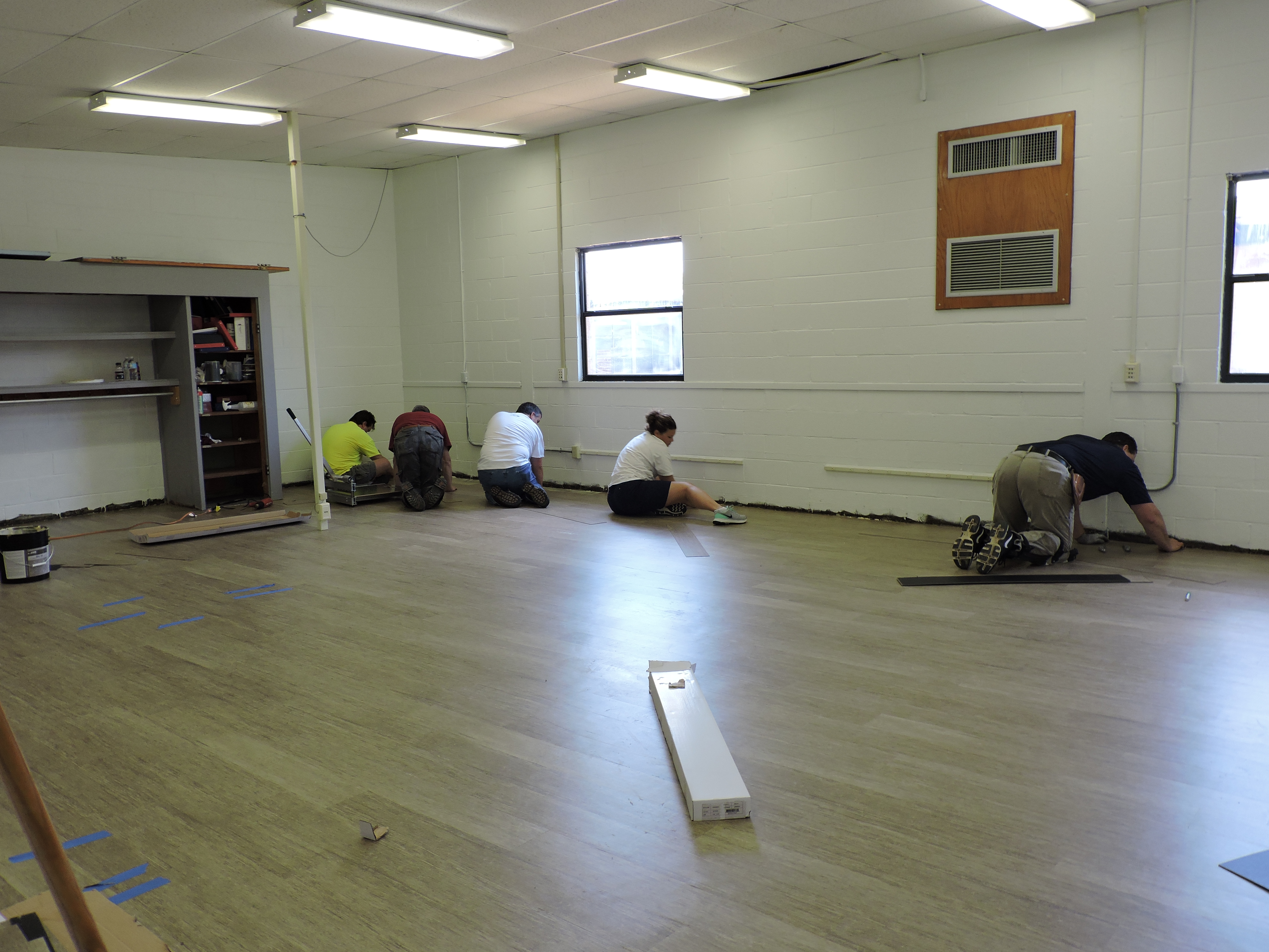 Shaw Industries workers lay flooring in a classroom inside the PLC. 