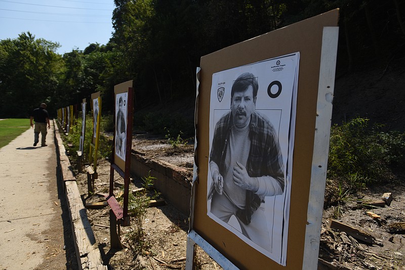Officer Joe Sabba walks past targets at the police firing range on Moccasin Bend Road. The city of Chattanooga is currently looking for a contractor to work on lead abatement at the range before turning the property over to the National Park Service.