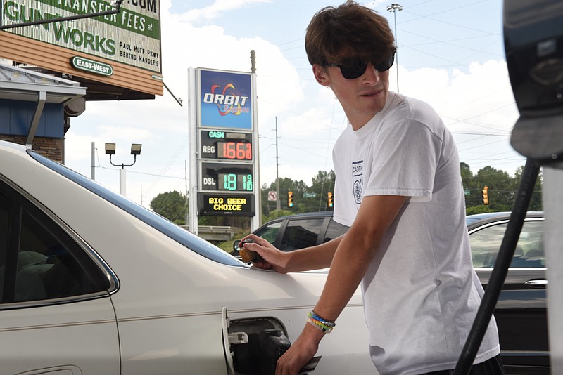 Cleveland resident Tommy Marino, 17, fills his tank with the lowest price gas reported in the area Monday on Paul Huff Parkway at Interstate 75.