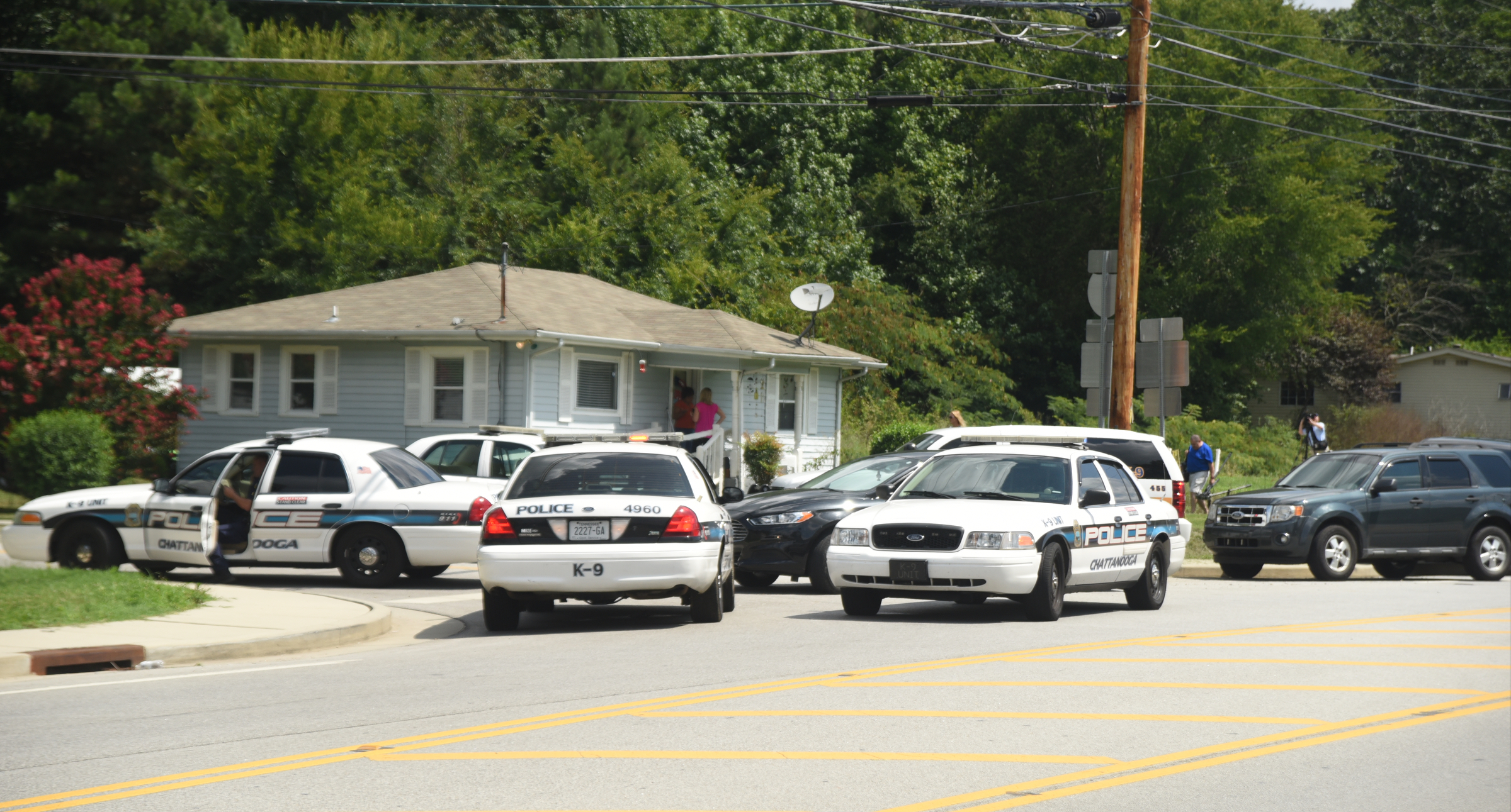 Officers are gathered on Old Lee Highway near the intersection of Apison Pike Monday, August 1, 2016 while searching for a man who fled police.