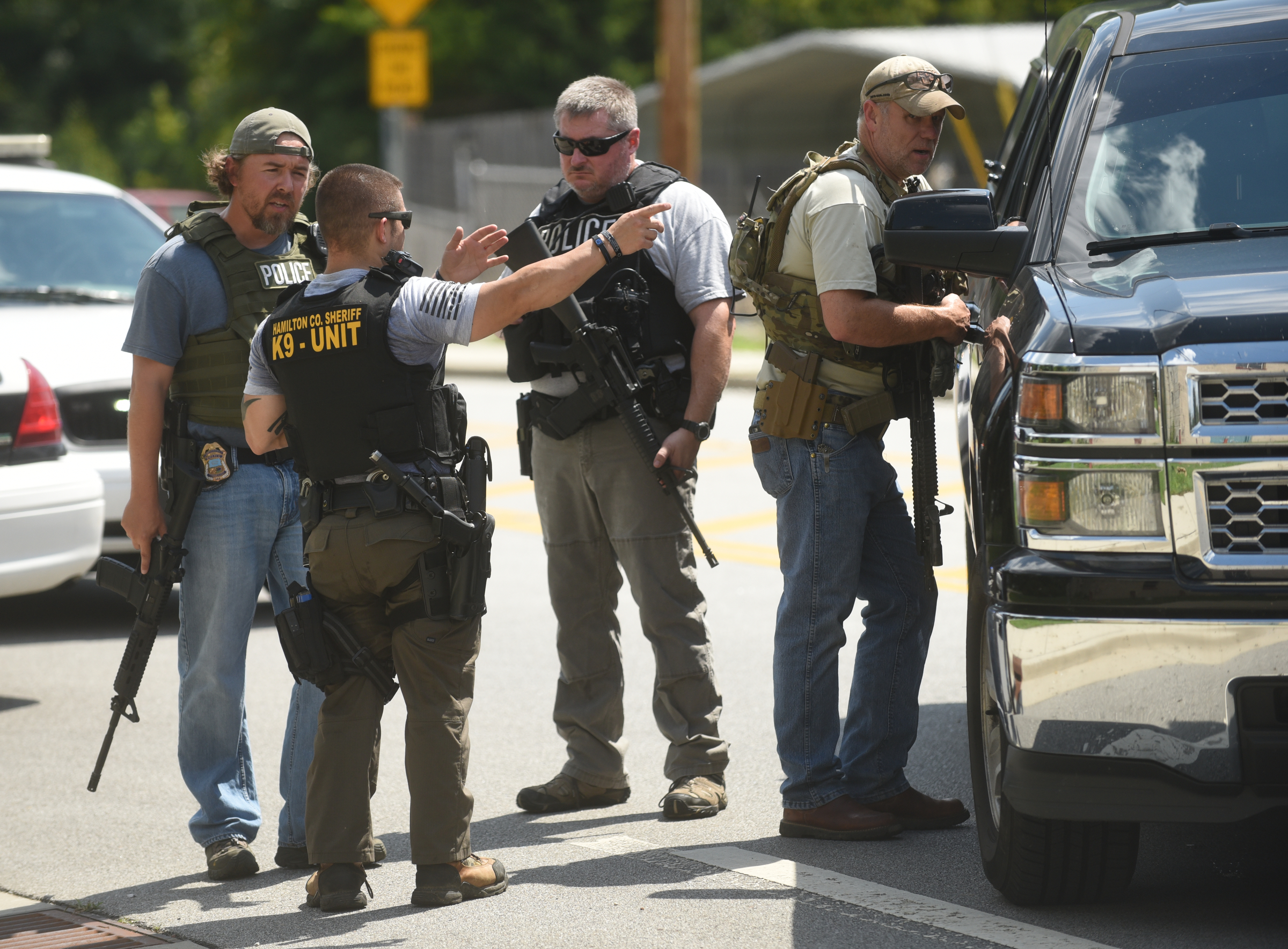 Officers are gathered on Old Lee Highway near the intersection of Apison Pike Monday, August 1, 2016 while searching for a man who fled police.