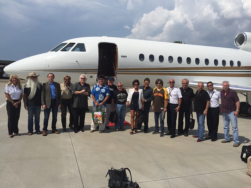 Nashville-based country music stars pose in front of a Jones-Airways-owned Falcon 900 jet in Nashville before departing for a police benefit show in Fort Worth, Texas, in July. Jones Airways donated the jet, in support of the Dallas Police Association's Assist the Officer Foundation.