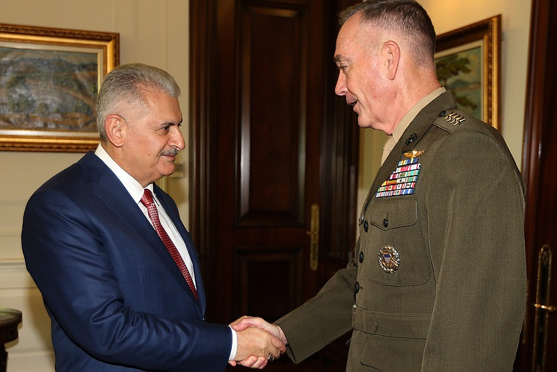 
              Turkey's Prime Minister Binali Yildirim, left, and The U.S. chairman of the Joint Chiefs of Staff, Gen. Joseph Dunford shake hands following a meeting in Ankara Turkey, on Monday, Aug. 1, 2016. Dunford visited U.S. military personnel stationed at Turkey's Incirlik air base Monday. He will later meet Prime Minister Binali Yildirim and Turkey's Chief of Staff, Gen. Hulusi Akar, who was briefly held captive by the coup plotters during the putsch. (Hakan Goktepe/Pool Photo via AP)
            