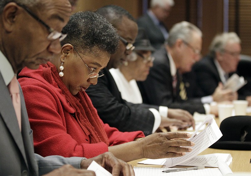 State Rep. Brenda Gilmore, D-Nashville, second from left, looks over a House Republican redistricting plan on Wednesday, Jan. 4, 2012, in Nashville.