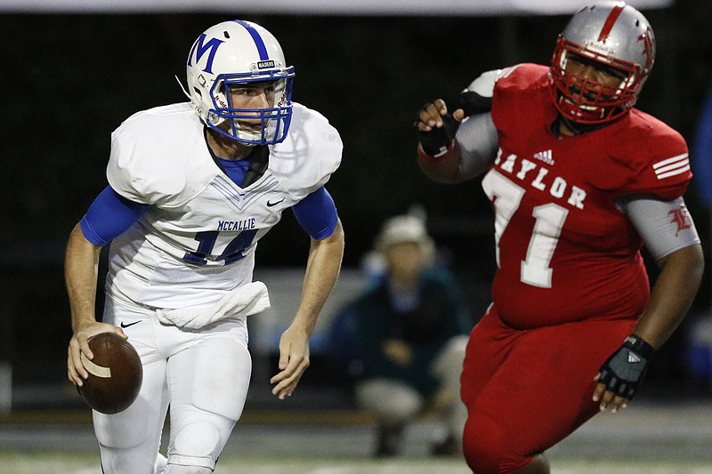 Staff Photo by Dan Henry / The Chattanooga Times Free Press- 10/2/15. Baylor School's Isaiah Strawter (71) puts the pressure on as McCallie School quarterback Robert Riddle (14) looks for an open receiver during the first half of play at the Red Raider's home field on October 2, 2015. 