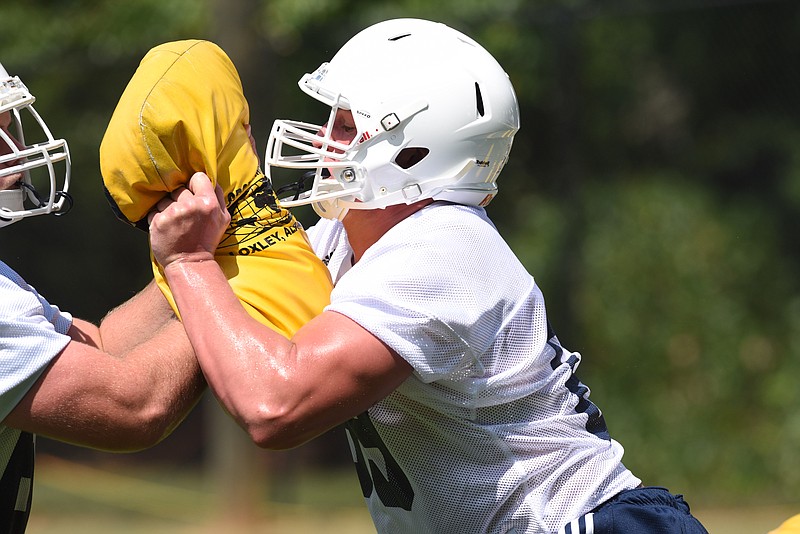 Cole Strange works on the offensive line in a feet, hips and finish drill on the first day of Mocs football practice at Scrappy Moore Field.
