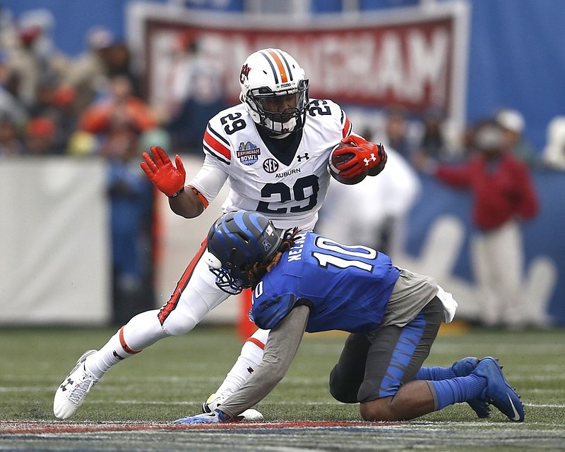 Auburn running back Jovon Robinson sidesteps the tackle attempt of Memphis defensive back Dontrell Nelson during the Birmingham Bowl last December. Robinson has been dismissed by Auburn coach Gus Malzahn.