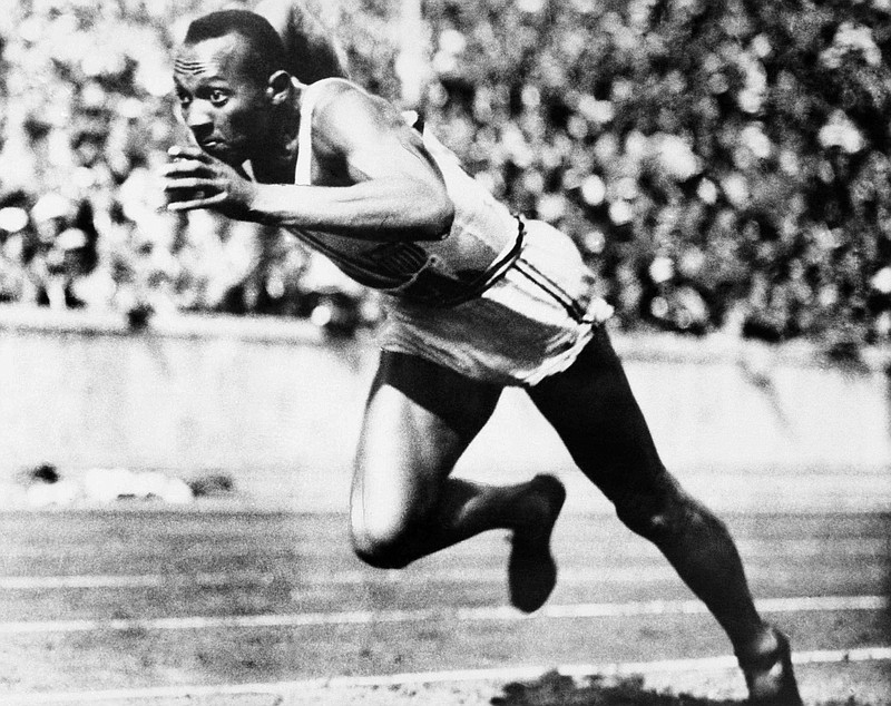 American sprint star Jesse Owens is shown in action during one of the heats of the 200-meter run August 14, 1936 in Berlin. He won the final with a new Olympic record of 20.7 seconds. (AP File Photo)