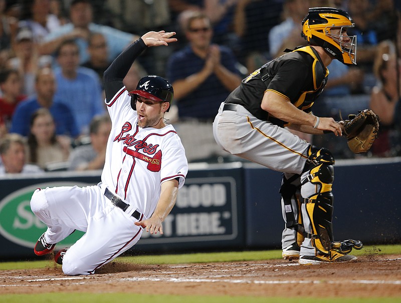 Atlanta Braves' Ender Inciarte (11) scores ahead of the throw to Pittsburgh Pirates catcher Eric Fryer (24) on a double by Anthony Recker in the fourth inning of a baseball game Wednesday, Aug. 3, 2016, in Atlanta.
