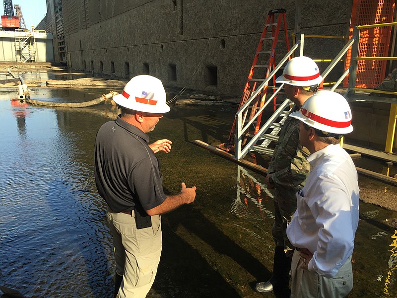 Greg Cox, the engineer in charge of the lock maintenance project, talks with U.S. Rep. Chuck Fleischmann and Lt. Col. Stephen Murphy in the dewatered lock chamber of the existing lock at the Chickamauga Dam.
