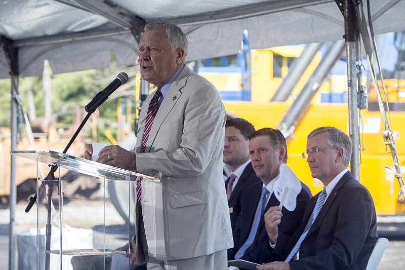 In this photo provided by the Georgia Port Authority, Georgia Gov. Nathan Deal, right, announces a deal, Wednesday, Aug. 3, 2016, in Cordele, Ga., between Kia Motors Manufacturing Georgia and Cordele Intermodal Services to move cargo by rail from the Port of Savannah. The arrangement saves transit costs for Kia Motors, while cutting millions of truck miles from state highways each year. 