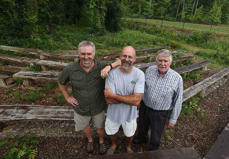 Silverdale Baptist Academy teachers Will Smith, center, and Tom Fuller, at right, built the outdoor theater with log seating that students will use as an outdoor classroom. The spot was intentionally left as close to its natural state as possible. With them is Al Rogers, left, SBA outdoor education director.