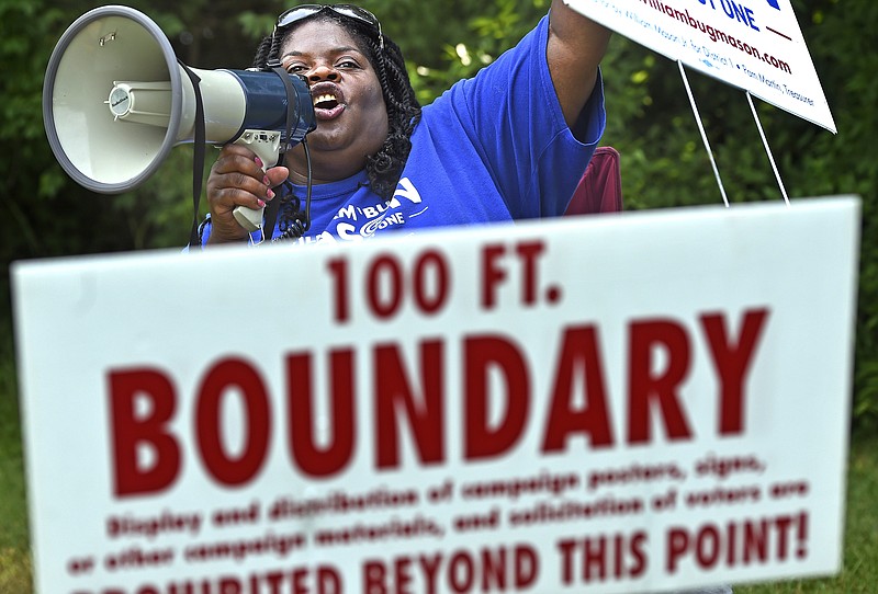 Staying just outside the 100-foot boundary, Carolyn Leach-Broyles and her bullhorn greets every voter with a push for her candidate as they arrive or leave during the Republican and Democratic primaries at the Bordeaux Library, Thursday, Aug. 4, 2016, in Nashville.