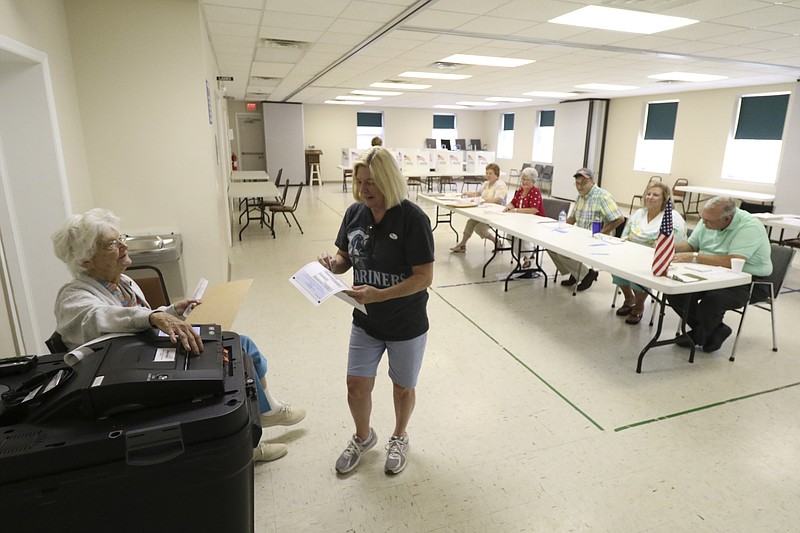 Deborah Parino turns in her ballot after voting at the District 1 Falling Water precinct on Thursday, Aug. 4, 2016.