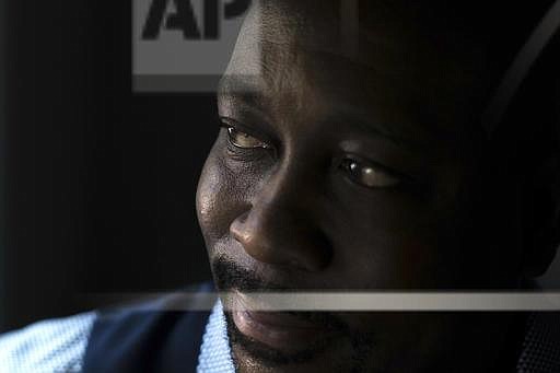 Air Force veteran Darryl Lewis poses for a portrait at his home, Thursday, Aug. 4, 2016, in Smyrna, Ga. Lewis filed a lawsuit in federal court in Washington saying he was illegally held and tortured by two top-ranking officials in Congo's government. (AP Photo/Branden Camp)