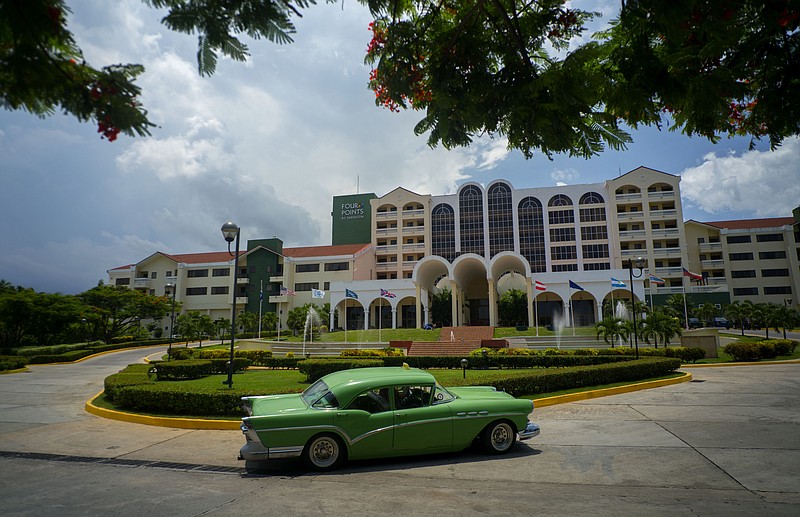 A vintage car, which are quite common in Cuba, passes in front of the Four Points by Sheraton hotel in Havana.