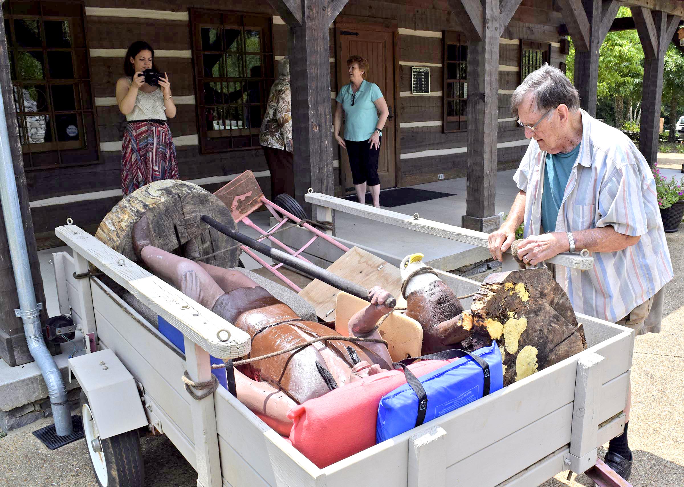 Ray Hoskins, who carved a sculpture of Cherokee interpreter John Spears donated this week to the Cherokee Removal Memorial Park in Meigs County, starts removing ropes from the piece after he and his wife, Shirley, hauled it to Tennessee from Atlanta.