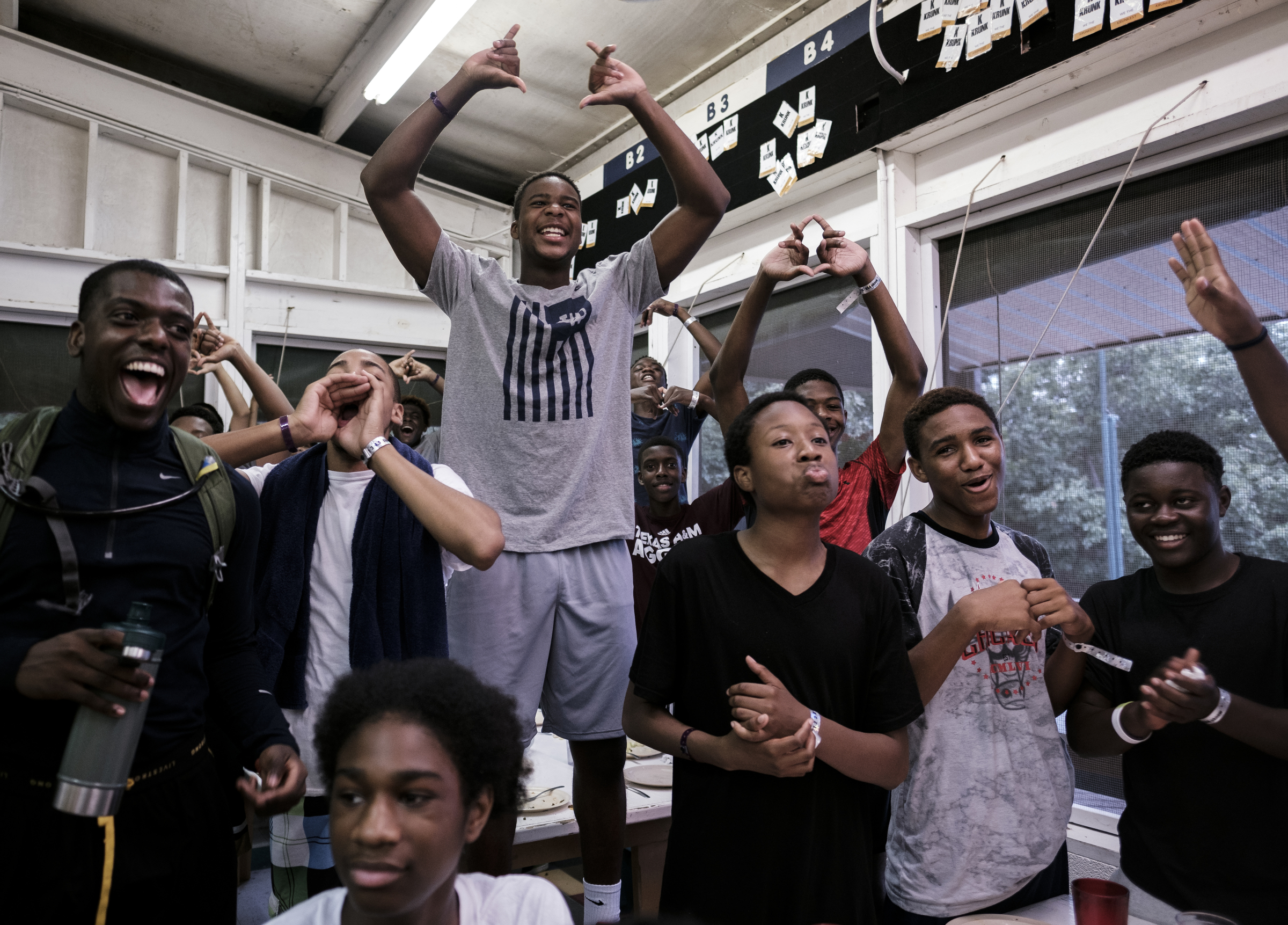 Cam Chambers, center, cheers with his table for their sister cabin as they compete against another cabin with skits after dinner at the Kids Across America camp Tuesday, July 26, 2016, near Branson, Mo. Chambers is one of many inner-city youths from Chattanooga brought to the camp by Chattanooga police officer Danny Jones.