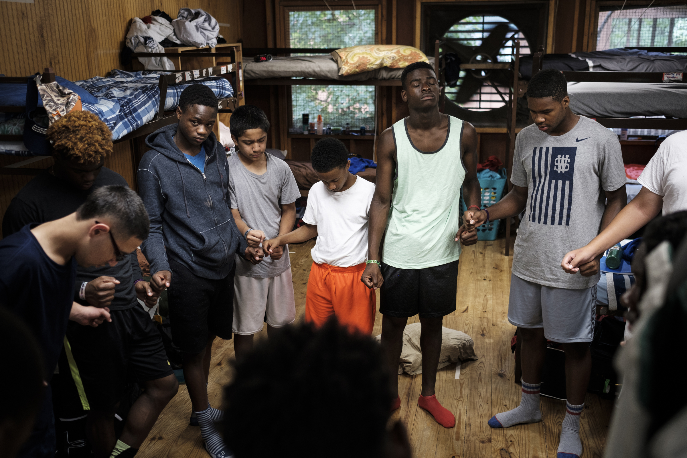 Cam Chambers, right, prays with his cabin after a Bible study session at the Kids Across America camp Wednesday, July 27, 2016, near Branson, Mo. Chambers is one of many inner-city youths from Chattanooga brought to the camp by Chattanooga police officer Danny Jones.