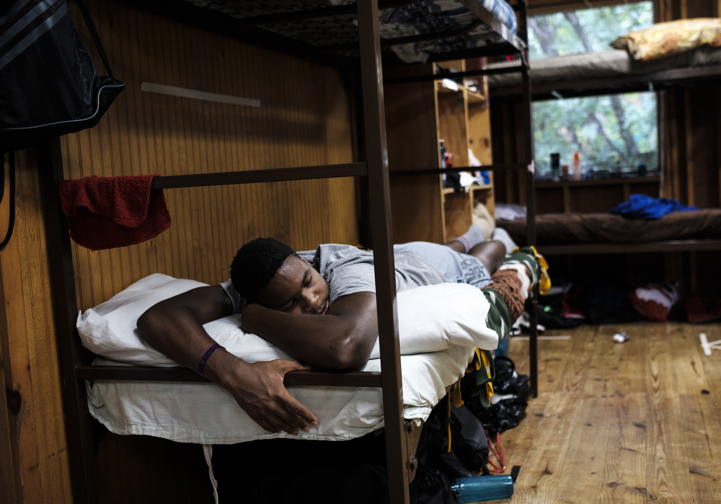 Cam Chambers rests in his cabin after Bible study before moving on to his first activity at the Kids Across America camp Wednesday, July 27, 2016, near Branson, Mo. Chambers is one of many inner-city youths from Chattanooga brought to the camp by Chattanooga police officer Danny Jones.