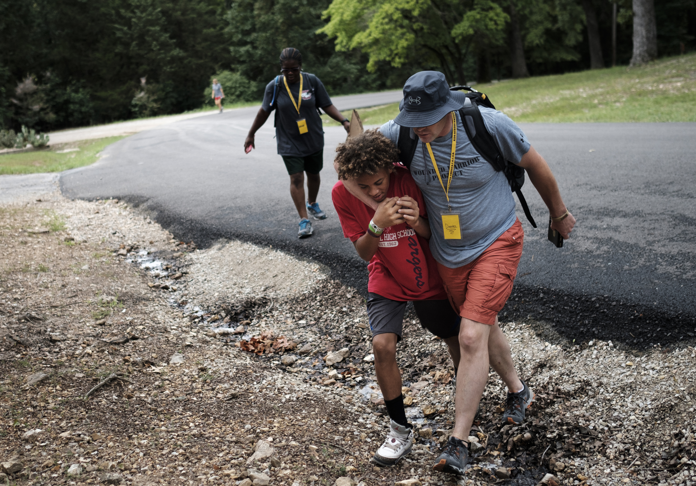 Chattanooga police officer Danny Jones, right, talks with Jesse Cowley as they head to a meeting between Jones and other Chattanooga area kids at the Kids Across America camp Wednesday, July 27, 2016, near Branson, Mo. Cowley is one of many inner-city youths from Chattanooga brought to the camp by Jones.