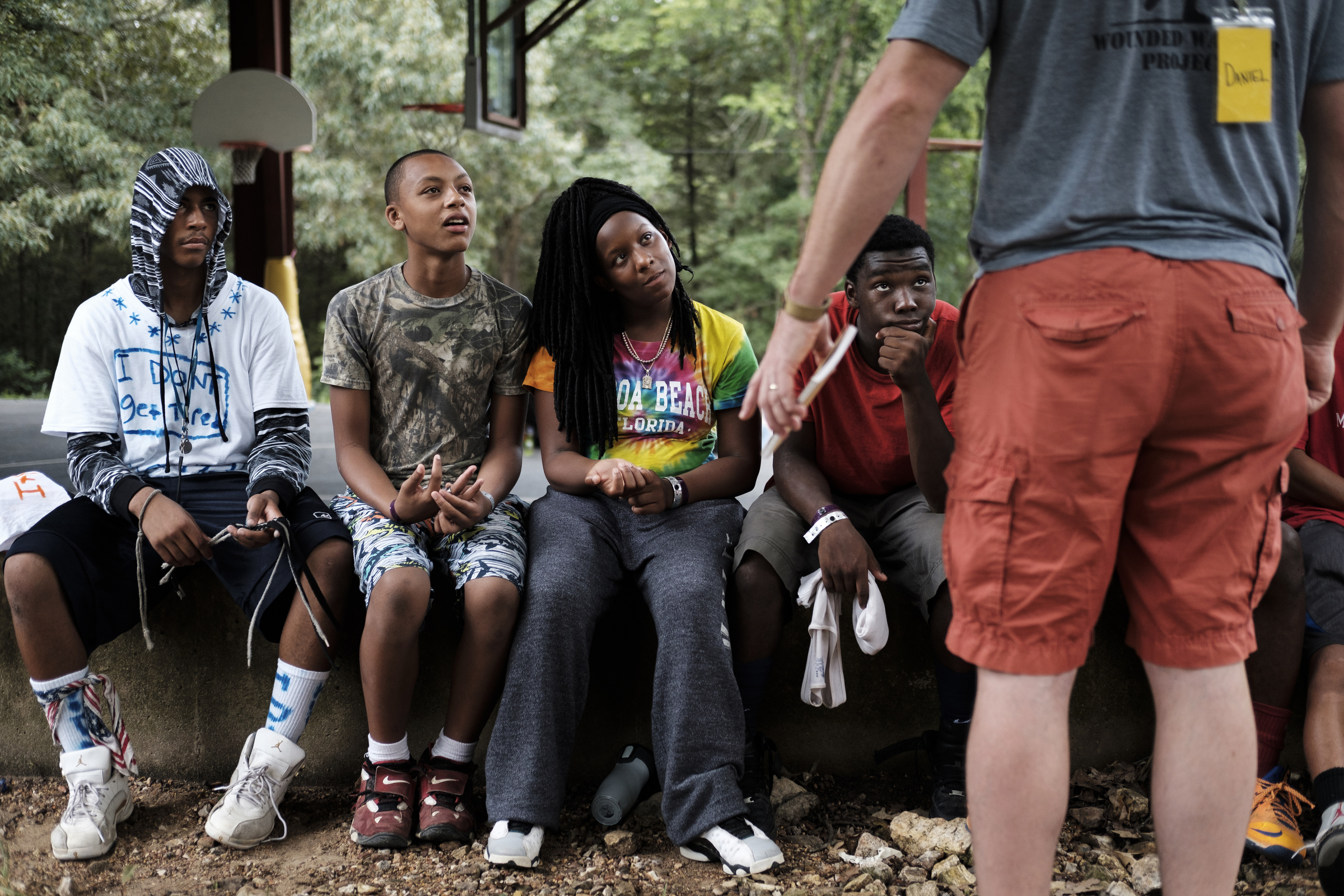 Chattanooga police officer Danny Jones talks with Chattanooga kids Deonte Readus, Chat Evans, Jr., Tyell Bush, and Shannahj Nelson, from left, during one of their meetings at the Kids Across America camp Wednesday, July 27, 2016, near Branson, Mo. Jones has brought inner-city youths from Chattanooga to the camp for 2 years.