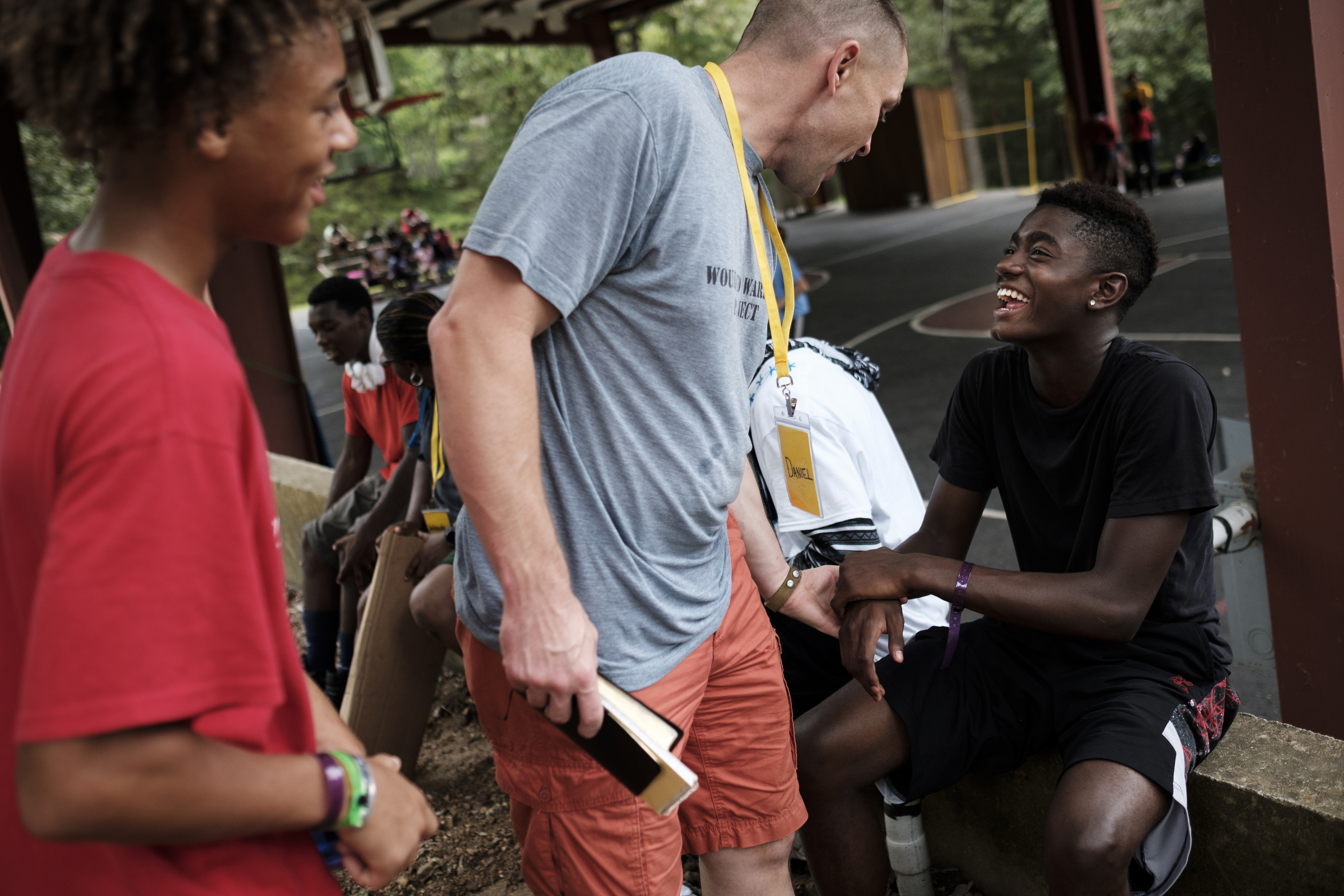Chattanooga police officer Danny Jones, center, talks with Jesse Cowley, left, and Dai'Sean 