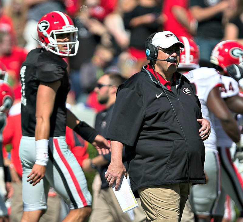 Georgia first-year offensive coordinator Jim Chaney is having to choose a starting quarterback among Greyson Lambert (background), Brice Ramsey and Jacob Eason.
