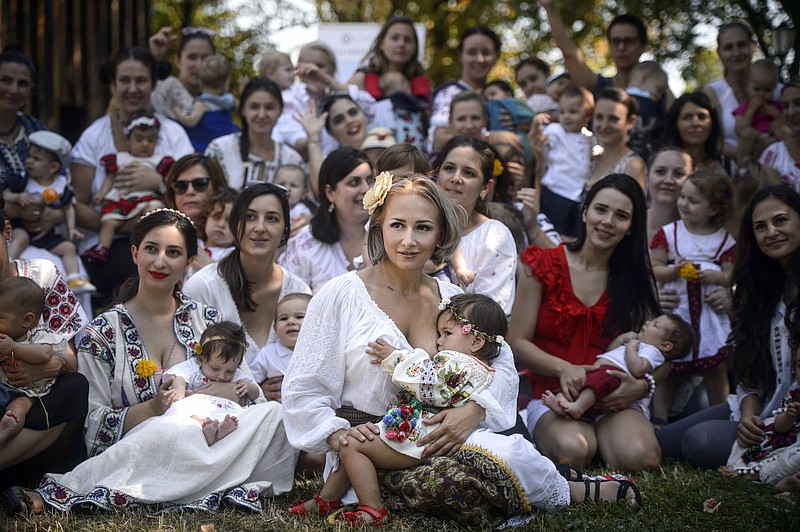 
              Women breastfeed their babies at an event promoting the freedom of mothers to breastfeed in public, during World Breastfeeding Week, at the Village Museum in Bucharest Romania, Saturday, Aug. 6, 2016. (AP Photo/Andreea Alexandru)
            