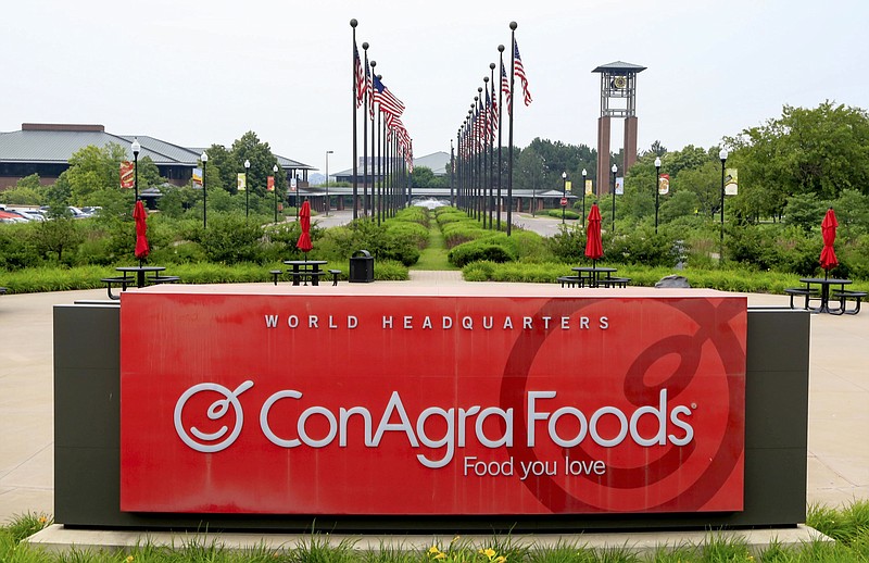 In this Tuesday, June 30, 2015, file photo, flags fly over ConAgra Foods world headquarters in Omaha, Neb. Nearly a decade after hundreds of Americans got sick after eating Peter Pan peanut butter tainted with salmonella, ConAgra Foods appears close to settling a federal criminal case stemming from the outbreak. Federal prosecutors announced last year that Chicago-based ConAgra had agreed to pay $11.2 million, a sum that includes the highest fine ever in a U.S. food safety case,and plead guilty to a single misdemeanor charge in the 2007 outbreak.